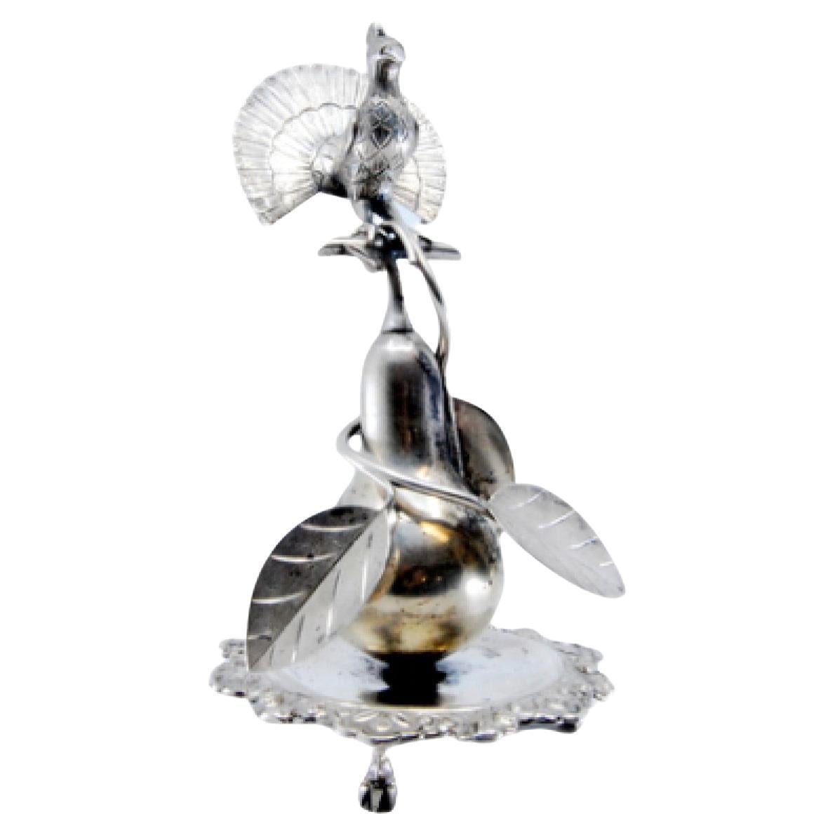 Silver toothpick holder with peacock perched on a pear tree