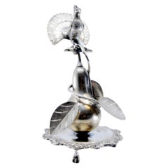 Silver toothpick holder with peacock perched on a pear tree