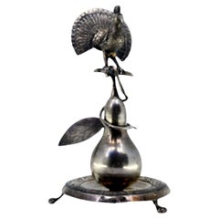 Silver toothpick holder with peacock perched on a pear tree