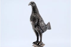 Silver toothpick holder with perched bird on circular three-foot base