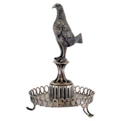 Silver toothpick holder with perched bird on circular three-foot base