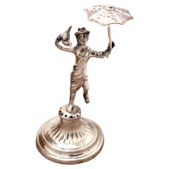 Silver toothpick holder with saleswoman on pedestal