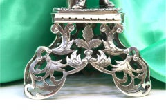 Silver toothpick holder with Turkish nobleman on carved tripod pedestal on trunk