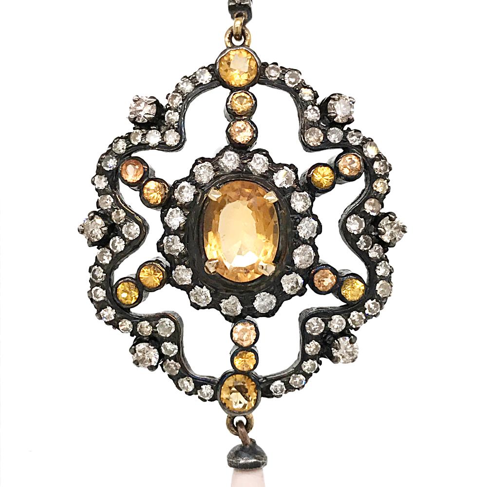 These irresistible earrings are crafted in silver-topped gold, presenting the unique and breathtaking beauty of antique jewelry. Displaying a pair of round plaque centered with oval-cut citrines, bezel-set with other 14 round-cut citrines weighing