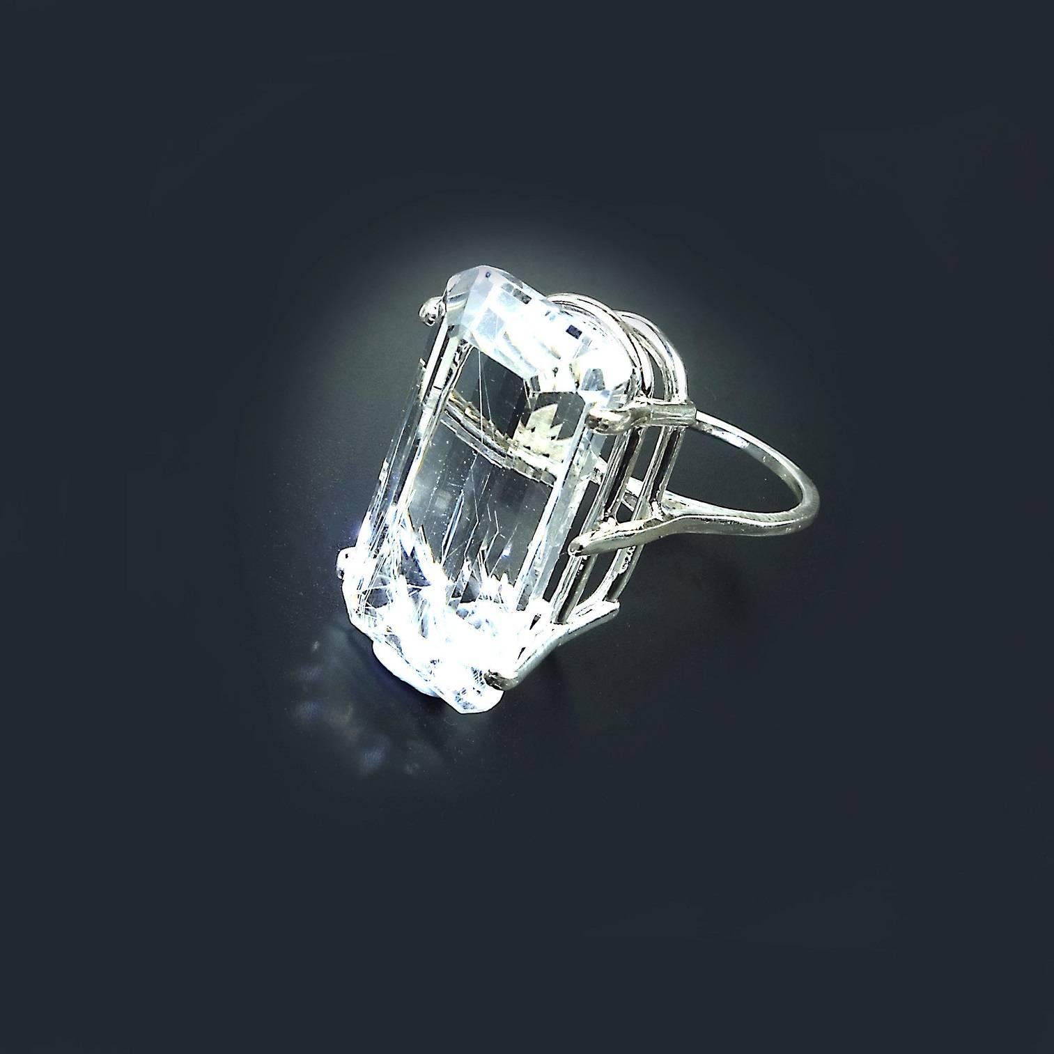 Custom made, sparkling Silver Topaz Emerald Cut Gemstone set in Sterling Silver Ring. This magnificent Silver Topaz is stunning! It reaches from knuckle to knuckle and flashes with every motion of your hand. It is approximately 50 carats of delight.