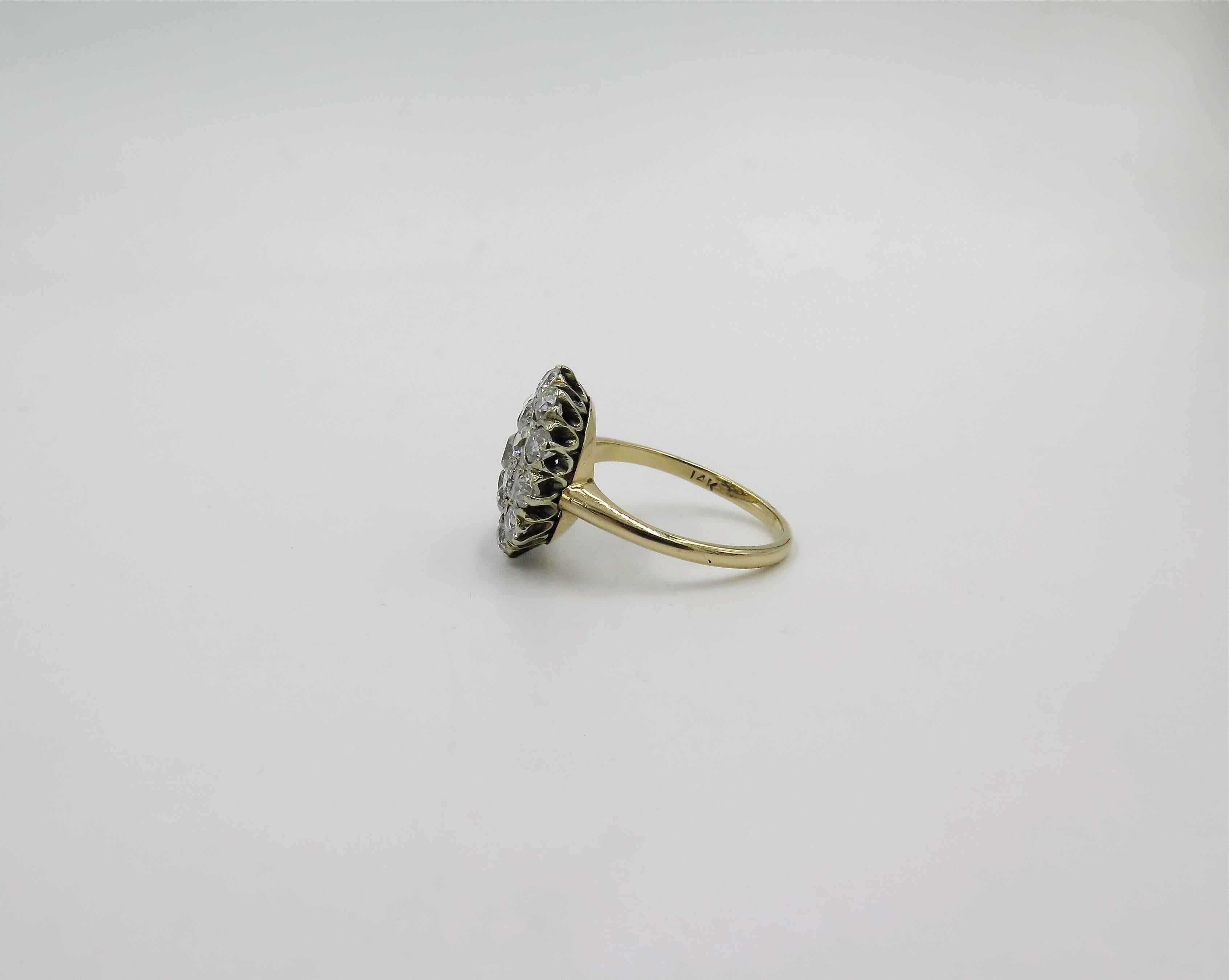 A silver topped 14 karat yellow gold and diamond ring. Circa 1930. Designed as a cluster of old European cut diamonds, with yellow gold shank. Twenty one (21) diamonds weigh approximately 2.00 carats. Size 7 1/4. Gross weight is approximately 3.5