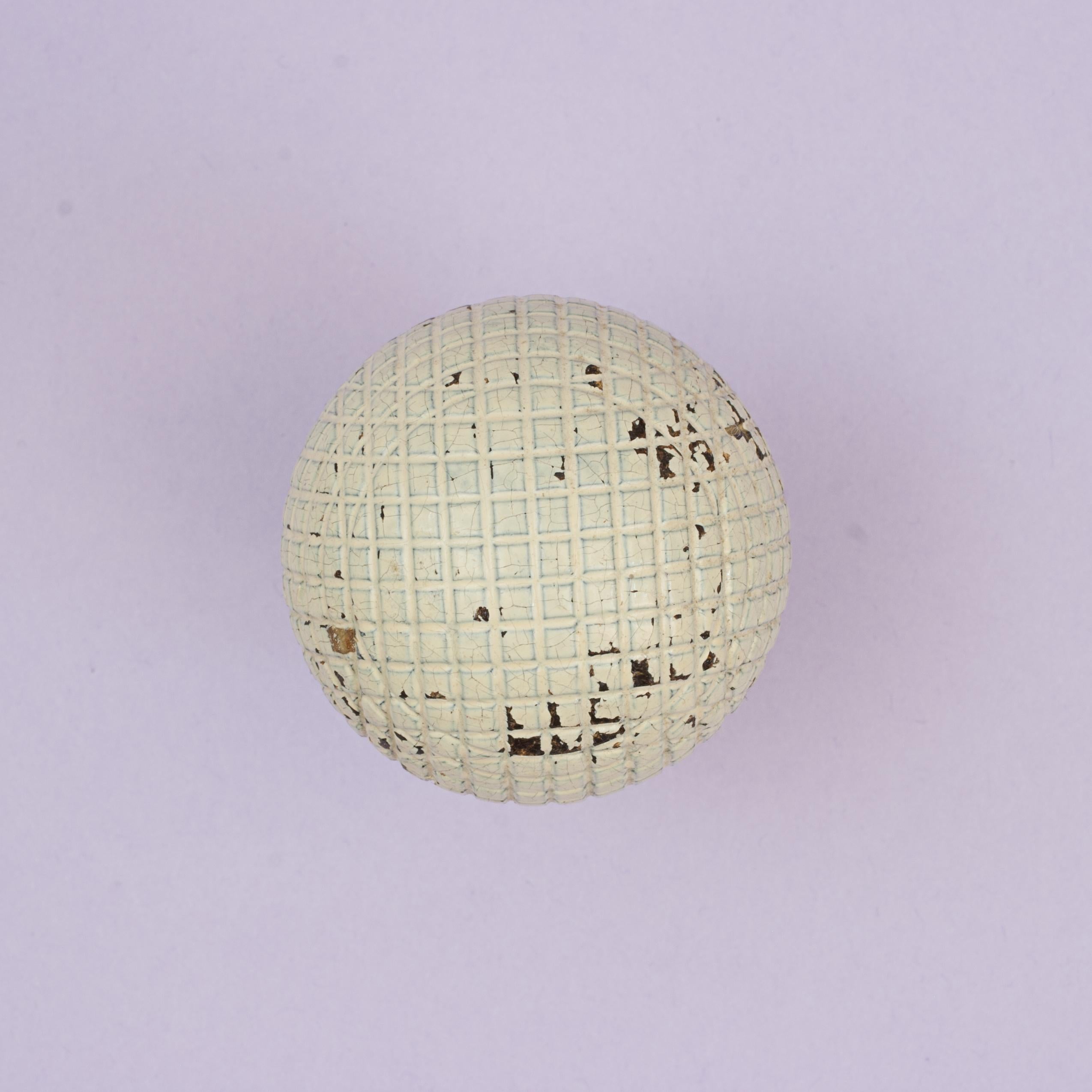 Solid Mesh 'Silvertown' Gutty Golf Ball.
A solid moulded square mesh patterned gutta percha golf ball in original, near mint condition. The mid 1890's 'SILVERTOWN' gutty ball manufactured by Gutta Percha Co., 100 & 106 Cannon Street, London & Wharf