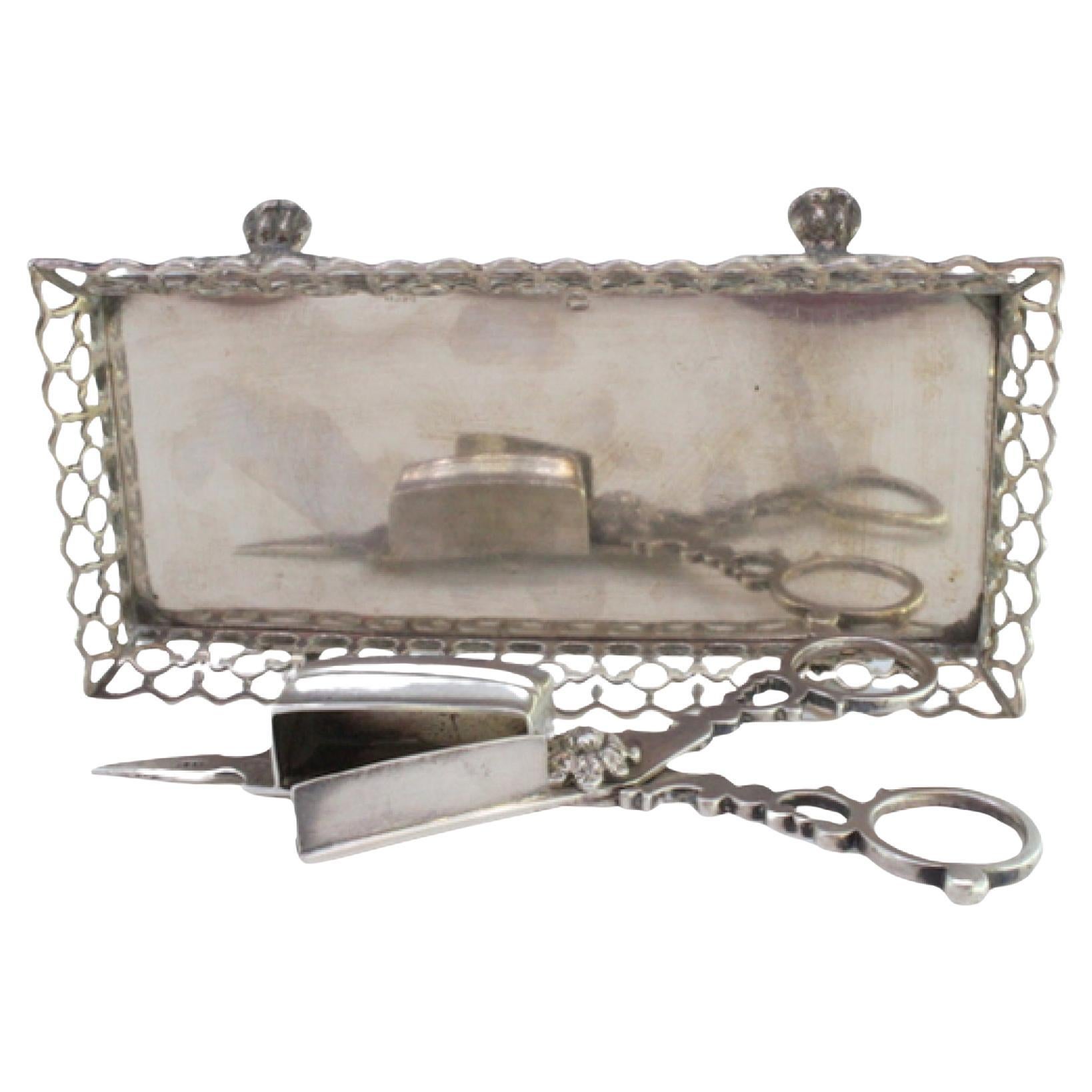 Silver tray and scissors with wire rack resting on four claw feet