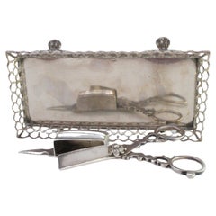 Silver tray and scissors with wire rack resting on four claw feet