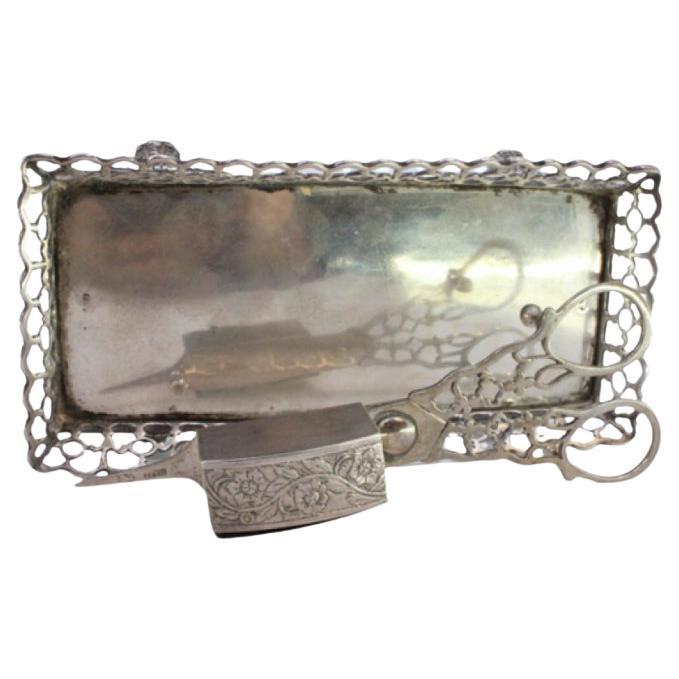 Silver tray and scissors with wire rack, resting on four claw feet