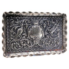 Silver tray embossed with flowers, birds and masks, wavy edge