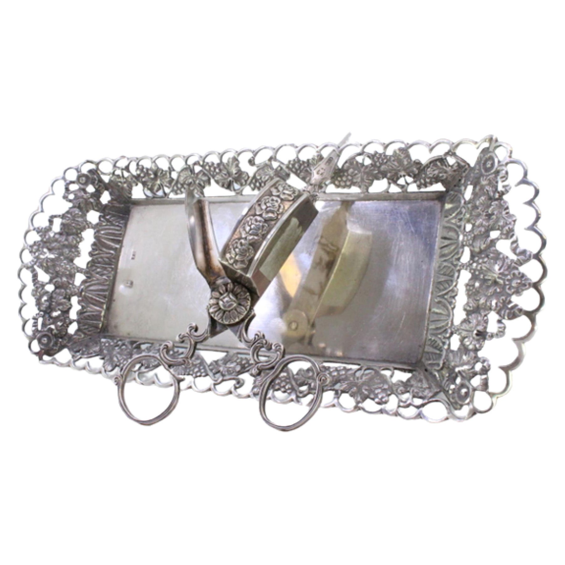 Silver tray 
scissors w/ chiseled grate 
resting on 4 raised claw-shaped feet