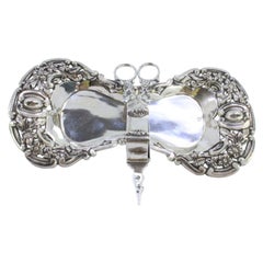 Silver tray 
scissors w/ cutouts, floral reliefs 
shell/flower feet