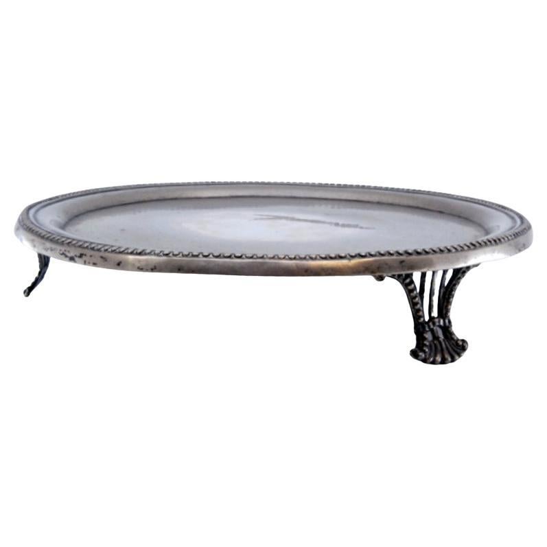 Silver tray w/ a smooth bottom, pearly frieze 
resting on three cut-out feet For Sale