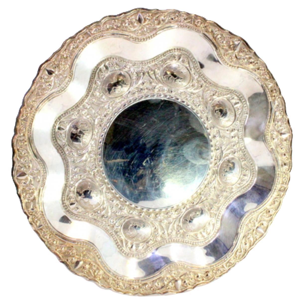 Silver tray w/ floral 
animal motifs in relief 
a smooth card in the center