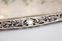 Silver tray with reliefs and cutouts