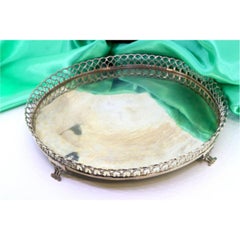 Silver tray with wire rack and resting on four cut-out feet