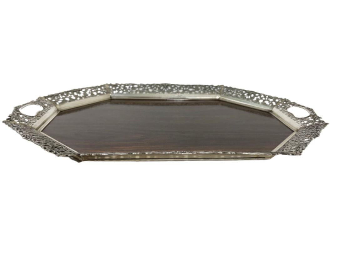 Silver tray with wooden melamine by H. Hooijkaas, 1974

A Dutch silver tray by H. Hooijkaas, Schoonhoven silver factory, Schoonhoven. Worked during 1946 - present. An 8-sided rectangular tray with wooden melamine bottom and the edge of Dutch