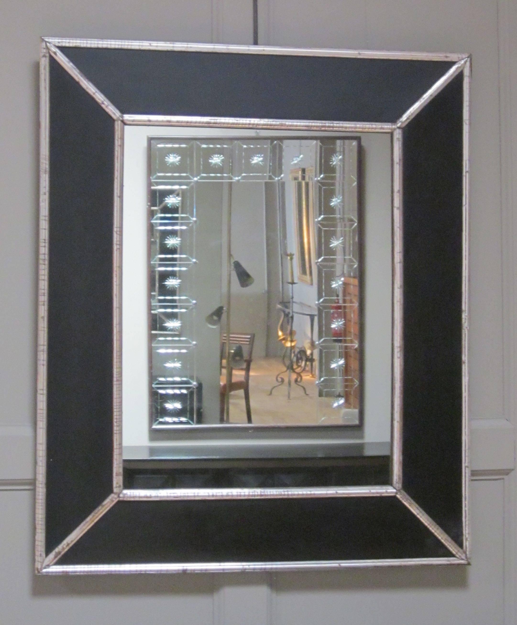 French 19th century black frame mirror with silver borders and mitered trim.
Black wood frame is trimmed in silver outlining the inside and outside of the frame and mitered corners.