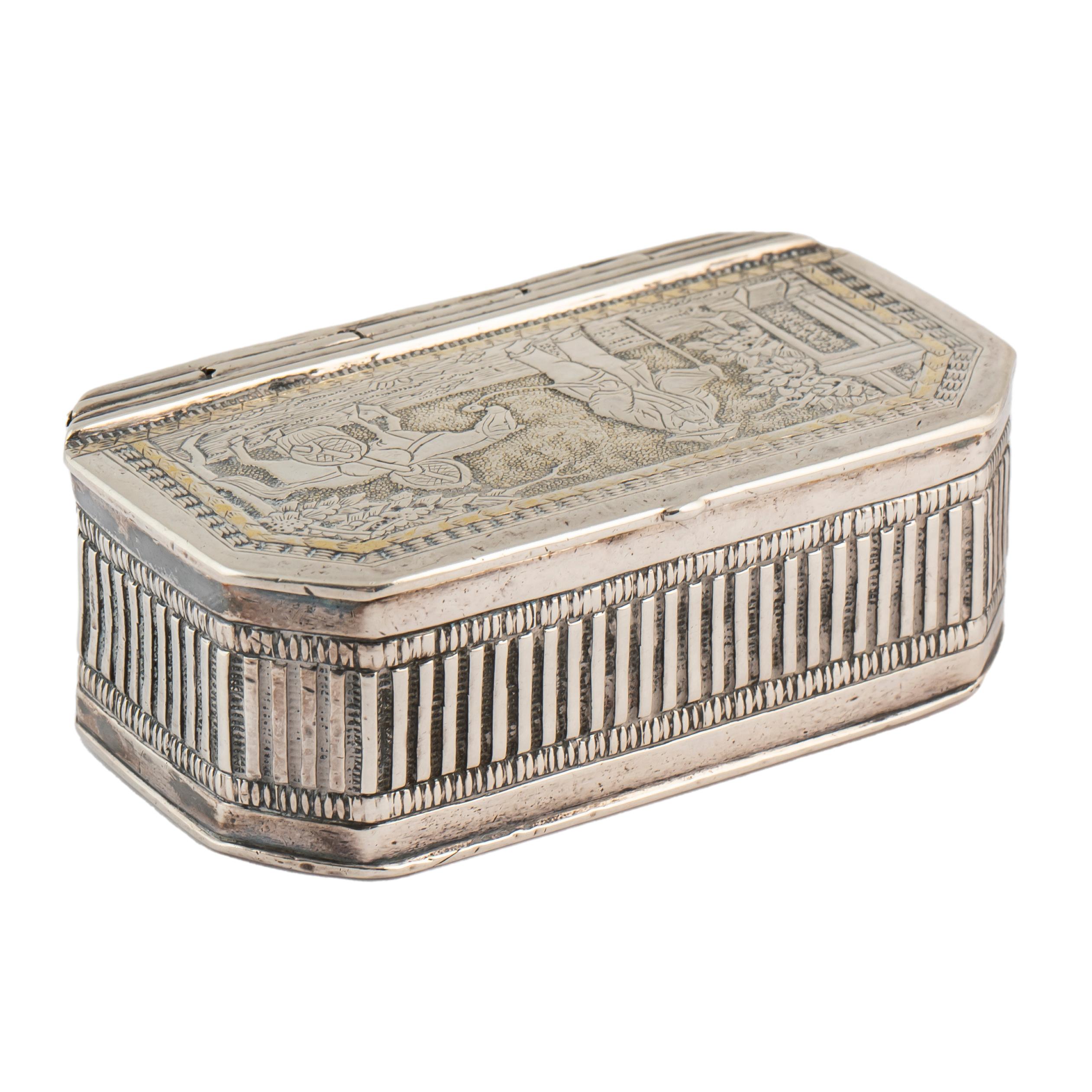 A heavy silver box with canted corners, the hinged cover in the style of an ancient traditional woodcut featuring a Chinese traveling figure or salesman with a walking stick in one hand, the other leading his horse burdened with baskets to a porch