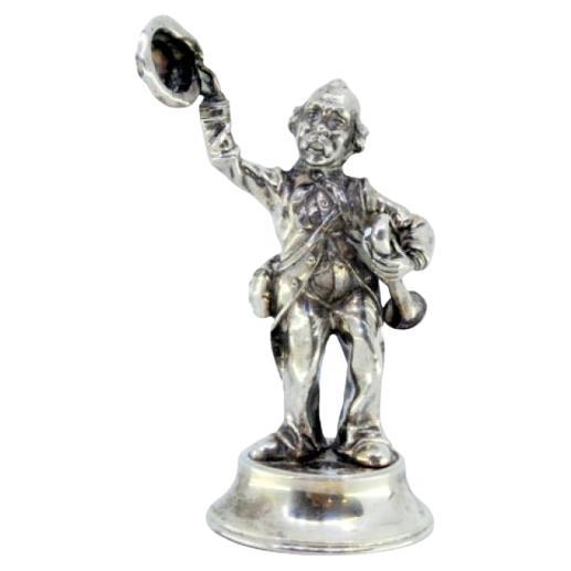 Silver trumpet player waving his hat and sitting on a round beaded base For Sale