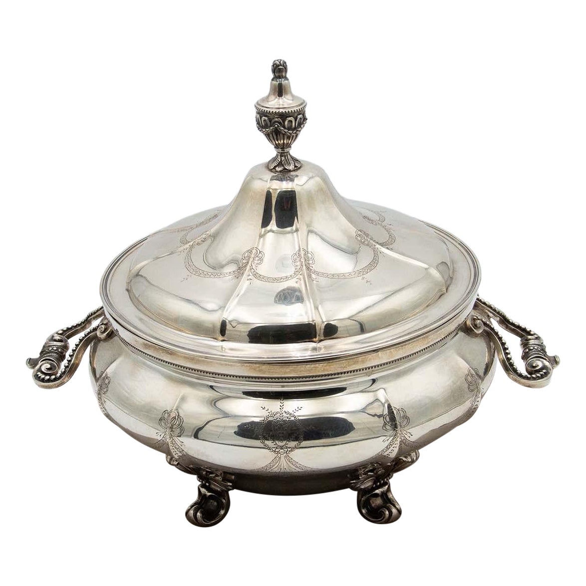 Silver tureen with eight sections, floral reliefs 
acanthus feet