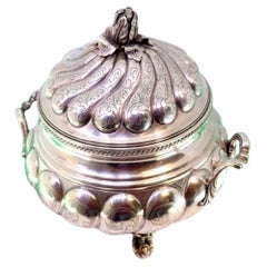 Silver tureen with fluted lid, floral handle, friezes & claw feet