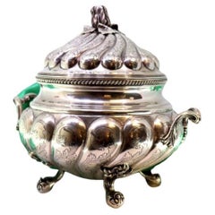 Silver tureen with fluted lid, floral handle, friezes 
claw feet