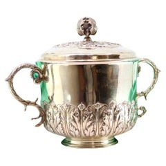 Silver tureen with reliefs, two handles 
beaded circular base