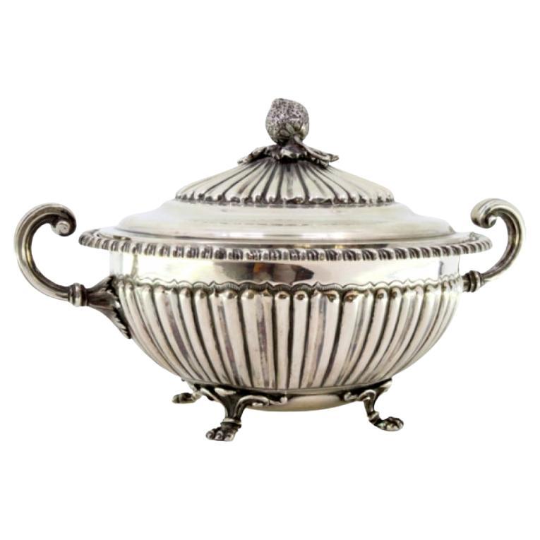 Silver tureen with reliefs, two handles 
claw feet