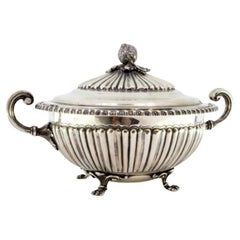 Silver tureen with reliefs, two handles 
claw feet