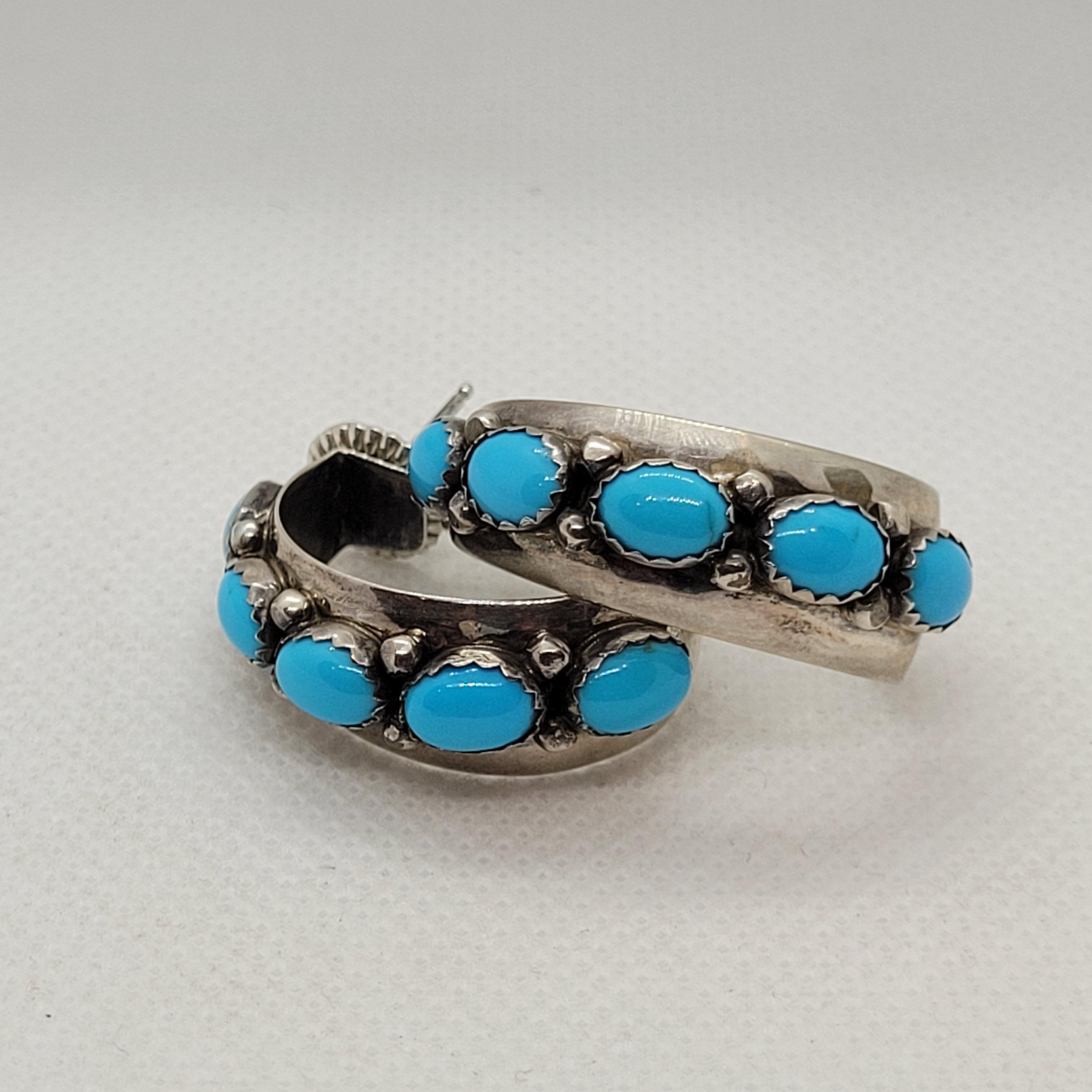 These stunning Silver Turquoise Hoop Earrings are a must-have for any jewelry collection. With 10 oval-shaped turquoise stones set in 925 stamped silver half-hoops, these earrings will add a touch of elegance to any outfit. The beautiful blue color