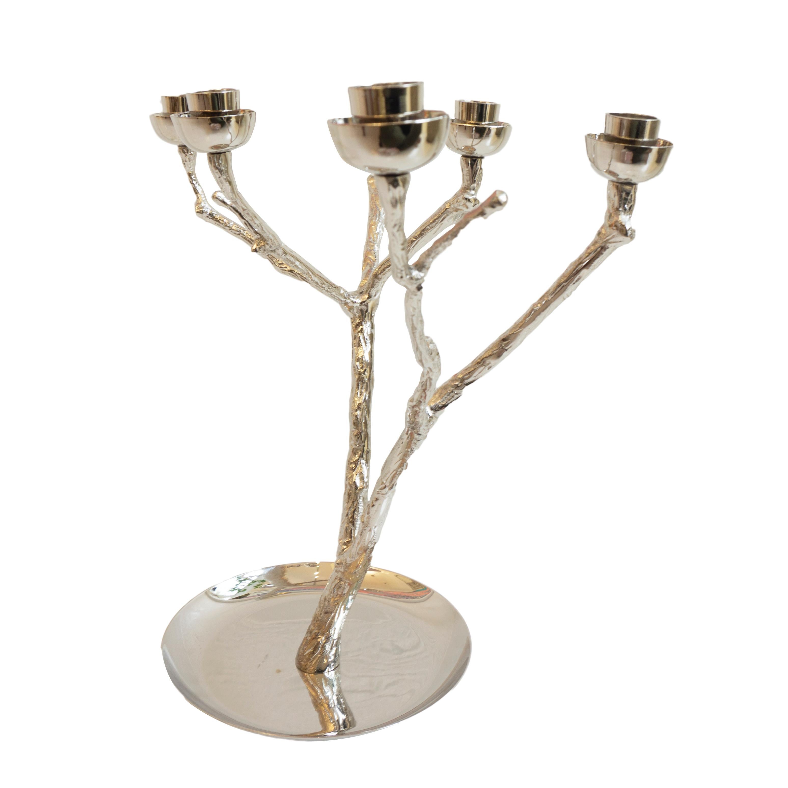 A metal candleholder in the shape of a branch with nickel plated finish. Holds six tapered candles. A great center piece. Handcrafted and designed from the Netherlands.

Measurements: 14” H x 16” W.
