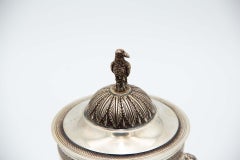 Silver urn resting on three raised feet