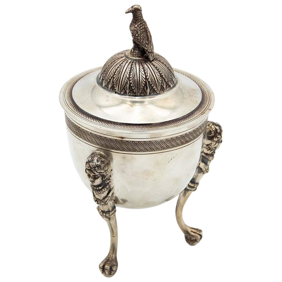 Silver urn resting on three raised feet