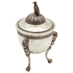 Silver urn resting on three raised feet