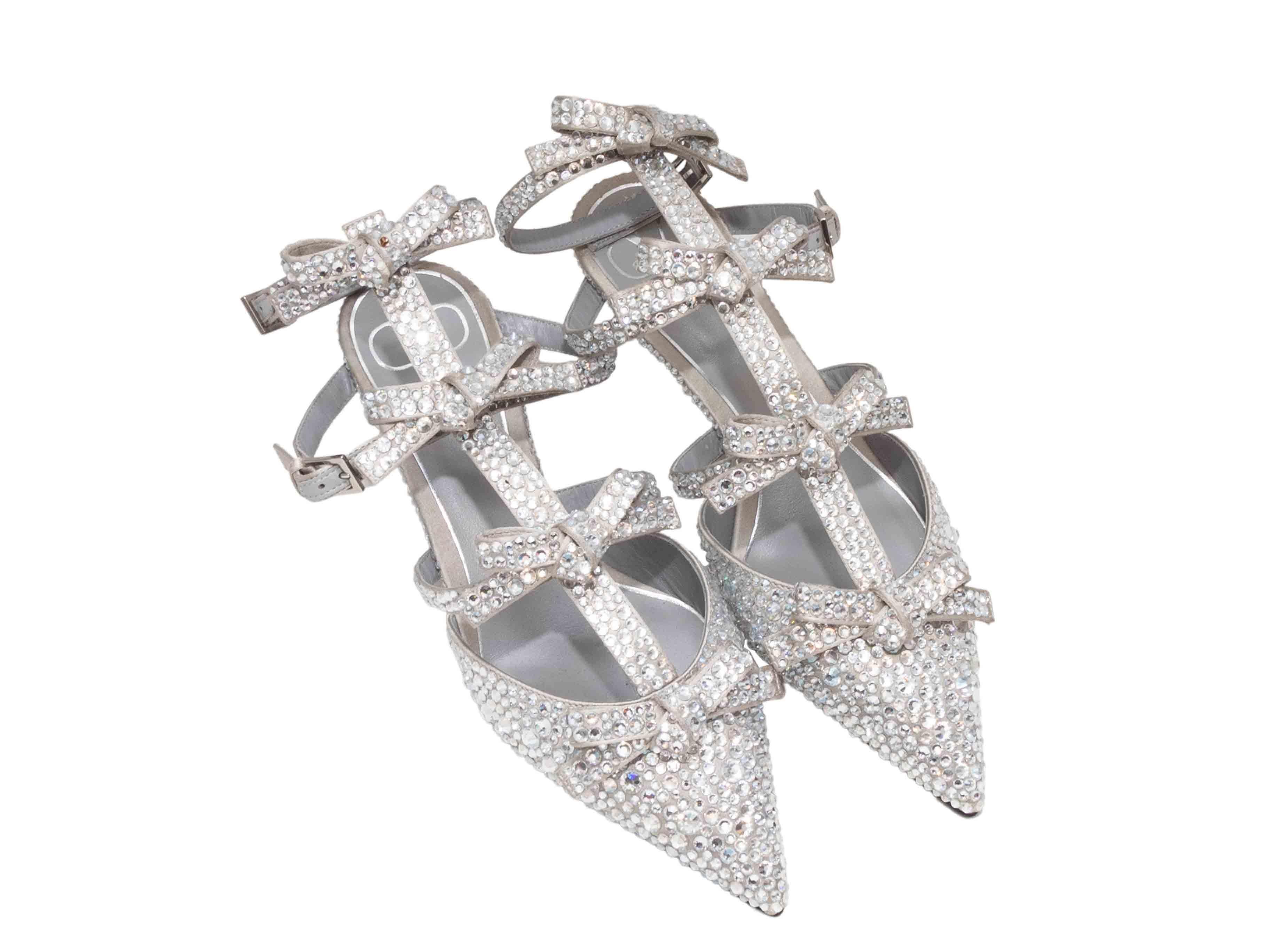 Silver pointed-toe crystal-embellished gladiator kitten heels by Valentino. Bow adornments at straps. Buckle closures at ankle straps. 5