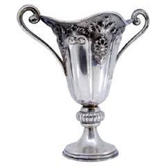 Silver vase embossed with shells, garlands, fluting and openwork handles