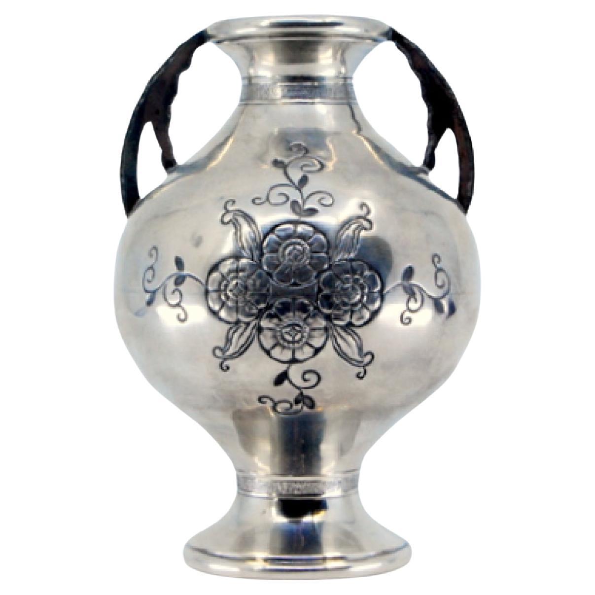 Silver vase with floral engravings, beaded rim, openwork handles, circular base