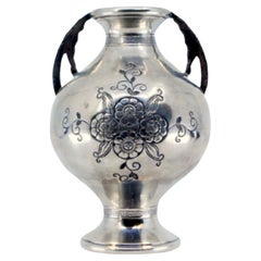 Silver vase with floral engravings, beaded rim, openwork handles, circular base