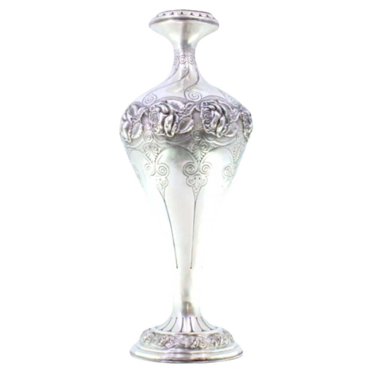 Silver vase with floral motifs and frilled circular base