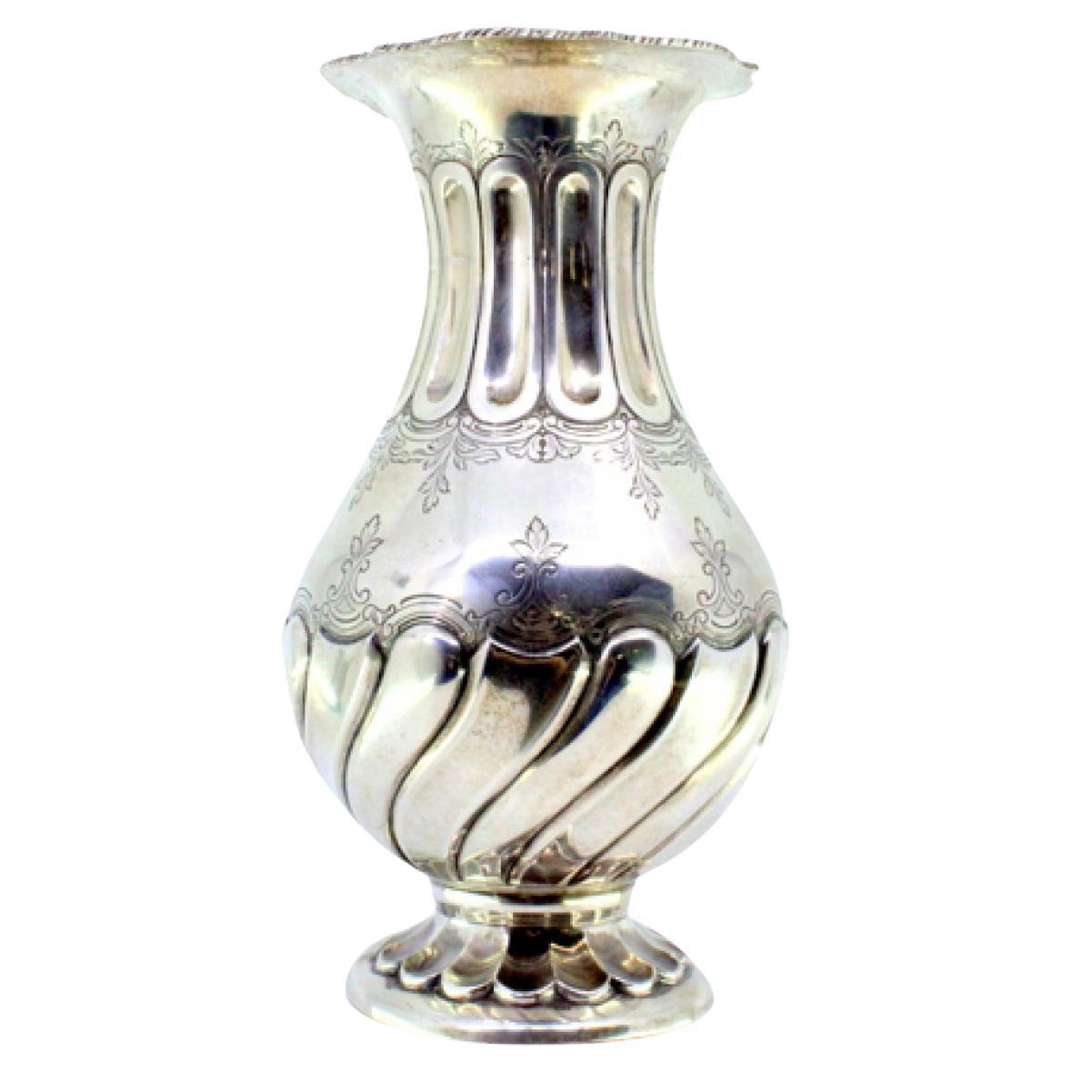 Silver vase with fluted rim and base, floral engravings, and rope frieze