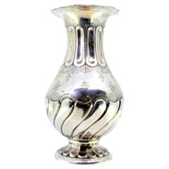Silver vase with fluted rim and base, floral engravings, and rope frieze