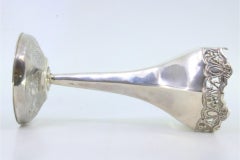 Silver vase with lace reliefs cut into the rim and circular base