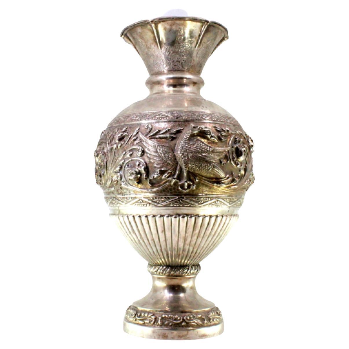 Silver vase with relief flowers, swan figures, and engraved friezes on base