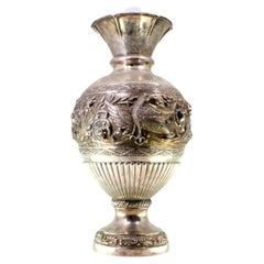 Silver vase with relief flowers, swan figures, and engraved friezes on base