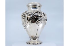 Silver vase with reliefs of shells and flowers with a circular base