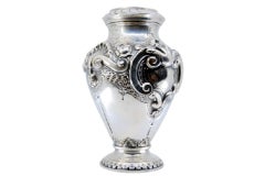 Silver vase with reliefs of shells and flowers with a circular base