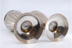 Silver vases with raised floral motifs, shells and circular bases
