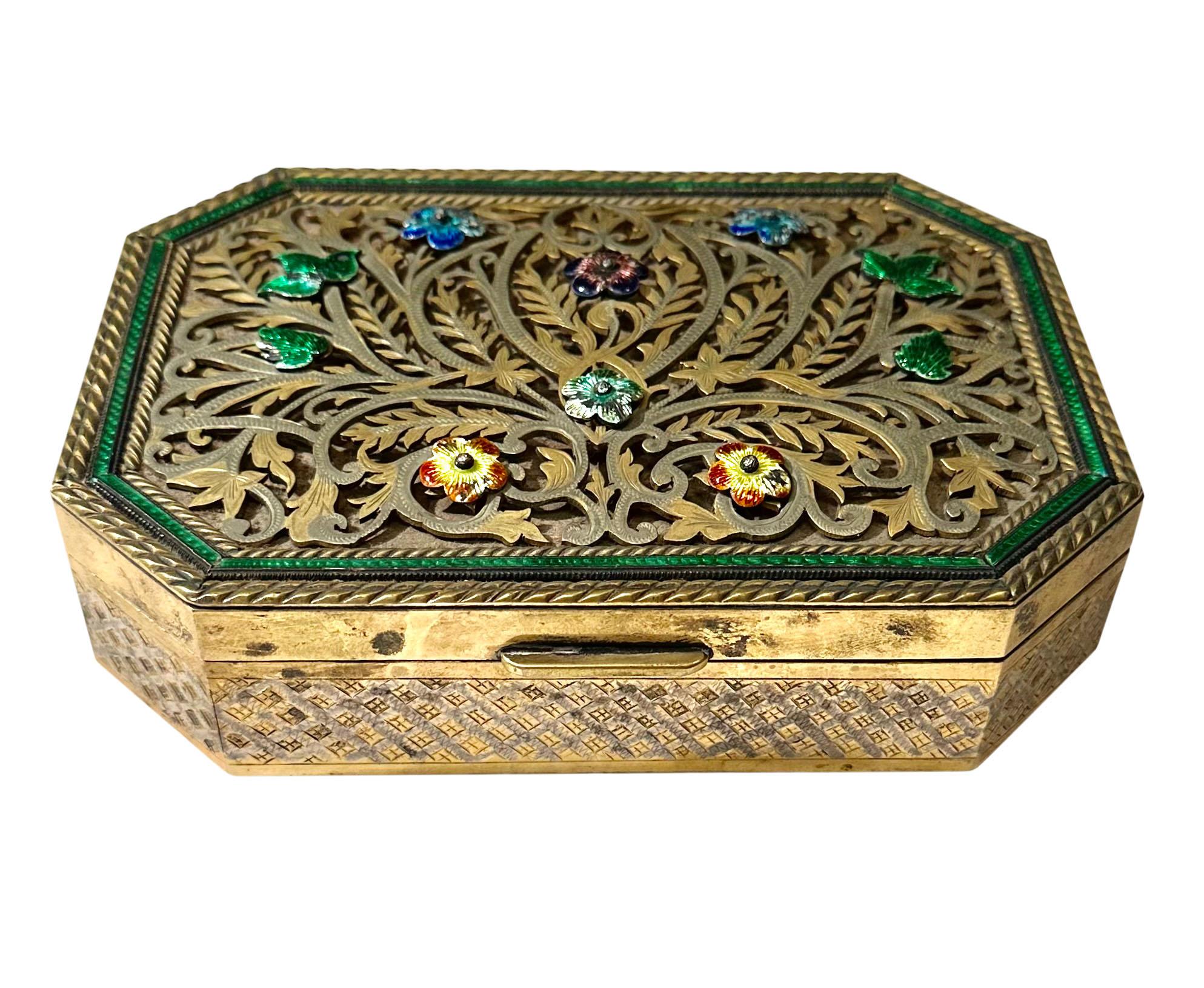A turn of the century silver Vermeil reticulated Indian box with enamel border and flowers. It was monogrammed on the bottom at a later date as a gift.